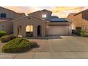 Charming single-Gathering home with a two-car garage, desert landscaping and solar panels on the roof at 16118 W Port Au Prince Ln, Surprise, AZ 85379