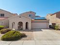 Charming single-Gathering home with a two-car garage, desert landscaping and solar panels on the roof at 16118 W Port Au Prince Ln, Surprise, AZ 85379