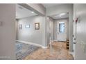 Inviting entryway featuring neutral tones, tile flooring, and seamless transition to living spaces at 16426 W Piccadilly Rd, Goodyear, AZ 85395