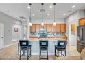 Spacious kitchen with a large island, granite countertops, and stainless steel appliances at 16426 W Piccadilly Rd, Goodyear, AZ 85395