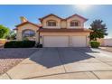 Charming two-story home featuring a two-car garage, red tile roof and a desert landscaped front yard at 2004 N 125Th Ave, Avondale, AZ 85392