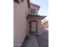 Inviting covered front entryway features a secure screen door and a charming archway at 22632 W Solano Dr, Buckeye, AZ 85326