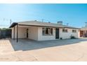 Angle shot of the front of the property showing the covered parking, fresh paint, and desert landscaping at 2342 N 40Th Ave, Phoenix, AZ 85009