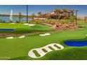 View of the lush putting green with water features and sand traps, set against a community clubhouse at 25052 N 174Th Ln, Surprise, AZ 85387