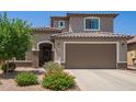 Charming two-story home features a well-manicured lawn, desert landscaping, and a spacious two car garage at 25546 N 164Th Dr, Surprise, AZ 85387