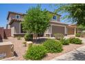 Charming two-story home features a well-manicured lawn, desert landscaping, and a spacious two car garage at 25546 N 164Th Dr, Surprise, AZ 85387