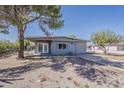 Cozy single-story home with a well-maintained front yard and a covered porch entrance at 2853 W Ohio St, Apache Junction, AZ 85120