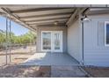 Covered patio with stylish lighting and a glass door entry, perfect for outdoor relaxation at 2853 W Ohio St, Apache Junction, AZ 85120