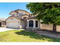 Charming two-story home featuring a well-maintained front yard and attached two-car garage on a sunny day at 2963 S 83Rd St, Mesa, AZ 85212