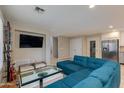 Cozy living room with sectional couch, modern coffee table, tv, and travertine floors at 312 S Hardy Dr # 106, Tempe, AZ 85281