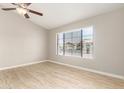 Bright bedroom with a ceiling fan, tiled floor, and a window view of the neighborhood at 3622 W Barcelona Dr, Chandler, AZ 85226