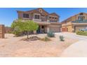 Two-story home featuring desert landscaping, a two-car garage and a neutral color scheme at 36645 W Bilbao St, Maricopa, AZ 85138