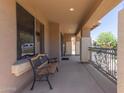 Charming front porch with a decorative bench and wrought iron railing at 36645 W Bilbao St, Maricopa, AZ 85138