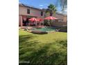 Beautiful backyard with a sparkling pool, mature landscaping, and ample space for outdoor entertaining at 45722 W Barbara Ln, Maricopa, AZ 85139