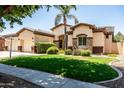Charming single-story home featuring a spacious three car garage, manicured lawn, and stone accents at 4614 E Reins Rd, Gilbert, AZ 85297