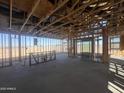 Interior view of a new home in progress with framing and sliding glass doors at 47437 W Kenner Dr, Maricopa, AZ 85139