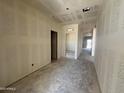 Hallway featuring smooth walls and ceiling, creating a modern aesthetic in a well-lit interior at 47437 W Kenner Dr, Maricopa, AZ 85139