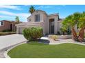 An attractive home featuring a well-manicured lawn, desert plants, and a charming front entrance at 641 W Oriole Way, Chandler, AZ 85286