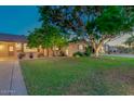 Well-kept home with a mature shade tree providing ample curb appeal and a welcoming entrance at 803 W 18Th St, Tempe, AZ 85281