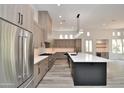Open kitchen with stainless steel appliances, large island, and seamlessly flows to dining area at 8934 E Rusty Spur Pl, Scottsdale, AZ 85255