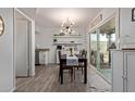 Open-concept dining room featuring modern light fixture and access to outdoor patio at 9047 N 52Nd Ave, Glendale, AZ 85302