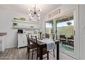 Bright dining room with modern chandelier, adjacent to the kitchen and outdoor patio at 9047 N 52Nd Ave, Glendale, AZ 85302