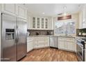The bright kitchen features white cabinets, stainless steel appliances, and granite countertops at 9280 E Davenport Dr, Scottsdale, AZ 85260
