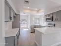 Modern kitchen featuring stainless steel appliances, gray cabinets, and quartz countertops at 101 N 7Th St # 168, Phoenix, AZ 85034