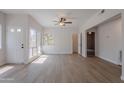 Bright and open living room featuring wood floors, a ceiling fan, and natural light at 101 N 7Th St # 168, Phoenix, AZ 85034