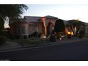Beautiful single-story home at dusk with decorative lighting, a tile roof, and manicured landscaping at 11290 N 117Th St, Scottsdale, AZ 85259