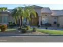 Charming single-story home with an arched entryway, a tiled roof, and mature palm trees enhancing curb appeal at 11290 N 117Th St, Scottsdale, AZ 85259