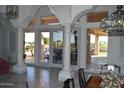 Beautiful outdoor patio and pool area viewed from the house through arched doorways at 11290 N 117Th St, Scottsdale, AZ 85259