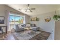 Bright living room features a comfortable couch, ceiling fan, and a view of the outdoors at 1212 S Boulder St # C, Gilbert, AZ 85296