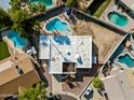 Aerial view of the home displaying the roof, landscaping, and several backyard swimming pools at 14830 N 28Th Pl, Phoenix, AZ 85032