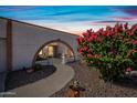 Inviting entryway with an arched walkway, desert landscaping, and views to the home's interior at 14830 N 28Th Pl, Phoenix, AZ 85032