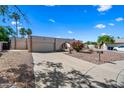 Single-story home featuring a two-car garage, arched entrance and low-maintenance desert landscaping at 14830 N 28Th Pl, Phoenix, AZ 85032
