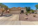 Inviting single-story home with a two-car garage, low maintenance landscaping, and desert rock at 16160 W Custer Ln, Surprise, AZ 85379