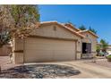 Charming single-story home featuring a two-car garage, low-maintenance landscaping, and desert rock at 16160 W Custer Ln, Surprise, AZ 85379