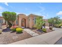 Inviting single-story home with desert landscaping, flowering shrubs, and charming covered entry at 1771 E Alegria Rd, Queen Creek, AZ 85140