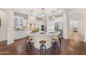 Gourmet kitchen featuring a large center island, custom cabinets, and stainless steel appliances at 1771 E Alegria Rd, Queen Creek, AZ 85140