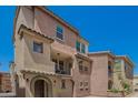 Beautifully designed townhome featuring a cozy front porch and attractive architectural details at 1836 N 77Th Gln, Phoenix, AZ 85035