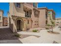 View of the beautiful townhome with a walkway and a charming front porch at 1836 N 77Th Gln, Phoenix, AZ 85035