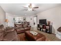 Open living room featuring a dark leather sofa set and access to kitchen and dining area at 2228 N 52Nd St # 140, Phoenix, AZ 85008