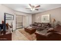 Inviting living room featuring a ceiling fan, stylish decor and sliding door access to the patio at 2228 N 52Nd St # 140, Phoenix, AZ 85008