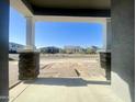Covered front porch with stone-clad columns and brick-paved walkway looking out onto neighborhood street at 22669 E Saddle Way, Queen Creek, AZ 85142
