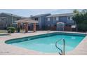 Community pool features a covered patio area with lounge seating and clear blue water at 2301 E University Dr # 269, Mesa, AZ 85213