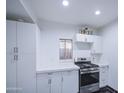 Bright kitchen featuring white cabinetry, stainless steel oven range and black and white tile floor at 2430 W Papago St, Phoenix, AZ 85009