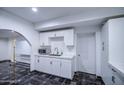 A well-lit room with white cabinets and a stylish black and white patterned floor at 2430 W Papago St, Phoenix, AZ 85009