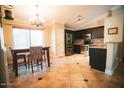 Eat-in kitchen featuring stainless steel appliances and a chandelier at 2533 N 114Th Ave, Avondale, AZ 85392