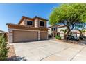 Inviting two-story home with a spacious three-car garage, long driveway, and mature landscaping at 2918 E Silverbell Rd, San Tan Valley, AZ 85143